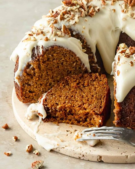 Carrot bundt cake is a perfectly moist carrot cake filled with freshly grated carrots and a blend of classic warming spices. Top this bundt carrot cake with a rich and tangy cream cheese glaze and crunchy pecans.  With its beautiful bakery worthy appearance and easy preparation, this carrot cake bundt cake is the perfect cake for all your holiday gatherings. Bundt Cake Carrot, Bundt Carrot Cake, Carrot Cake Decorating Ideas, Filled Bundt Cake, Spiced Bundt Cake, Carrot Cake Bundt, Carrot Bundt Cake, Beautiful Bakery, Cream Cheese Bundt Cake