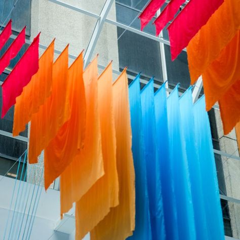 Hanging sunburst fabric installation for the Textile LA show. This colorful art piece hangs from the ceiling of the California Market Center lobby. Corrie in Color is a creative studio specializing in custom event decoration and art installations that bring events and interiors to life. #textileinstallation #backdrop #experiential #design Ceiling Art Installation, Experiential Graphics, Fabric Installation, Fabric Ceiling, Ceiling Art, Stage Set Design, Hanging Fabric, Exhibition Stand Design, Ceiling Installation