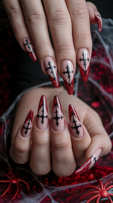 Embrace your dark side with these gothic-inspired stiletto nails! The nude base elegantly frames a striking black cross design that fans out, while vibrant red glitter at the tips adds a captivating touch. Set against a vampy red velvet backdrop with spider web accents, these nails are perfect for Halloween or any occasion when you want to make a bold statement!
#halloweennails #halloweenvibe #halloweeninspo #acrylicnails #nailsdesign #octobernails Dark Red Nails Halloween, Gothic Cross Nails, Gothic Holiday Nails, Ruby Gloom Nails, Gothic Fall Nails, Vampy Nails Almond, Black Nails With Cross Design, Elvira Nails, Red Spider Nails