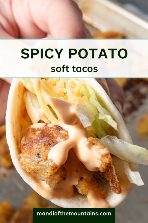 Closeup of a potato taco with creamy chipotle sauce, lettuce, and cheese. Spicy Potato Tacos Taco Bell, Spicy Potato Soft Taco Taco Bell, Taco Bell Potato Soft Taco, Taco Bell Spicy Potato Taco, Potato Soft Tacos, Spicy Potato Tacos, Rolled Cabbage, Taco Bell Potatoes, Taco Sauce Recipes