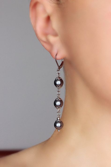 Beautiful long pearl earrings with dark gray finest quality European crystal pearl coated 8 mm beads, stainless steel flower shape bead caps, tiny steel beads-separators and stainless steel lever back earring hooks. Earring hooks are from nickel free and lead free metal. *The total lenght of earrings is about 66 mm including earring hooks. Other earrings of my shop you can see here:  https://www.etsy.com/shop/NaTavelli?section_id=13757927  Thanks for visit. Dangle Crystal Earrings, Simple Bead Earrings, Pearl Bead Earrings, Crystal Bead Earrings, Grey Pearl Earrings, Diy Earrings Easy, Long Pearl Earrings, Earring Beads, Jewelry Making Earrings