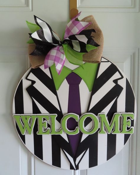 Beetlejuice Halloween Door Hanger Bring a touch of spooky fun to your Halloween decor with our 16" Beetlejuice Halloween Door Hanger. Inspired by the iconic character, this door hanger is sure to add a playful and eerie vibe to your home, delighting guests and trick-or-treaters alike. #DoorDecor #doorsign #frontporch #halloween #moviedecor https://www.maker-mall.com/beetlejuice-halloween-door-hanger/ Halloween Pumpkin Door Hanger, Beetlejuice Door Decor, Painted Wood Door Hangers, Beetlejuice Door Hanger, Beetlejuice Halloween Decorations Diy, Beetlejuice Wreath, Beetlejuice Sign, Holiday Door Hangers, Halloween Door Signs