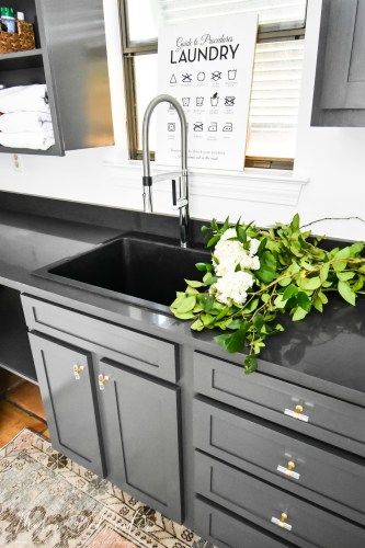 A laundry room sink, also called a utility sink or laundry sink, can be a major convenience if you have the space for one in your home. Read on to see the laundry room sink I chose for our new laundry room and why I love it! #laundryroom #laundryroomsink #utilitysink #utilityroom #laundry #wayfair #blanco #blacksink Utility Sink With Counter, Black Utility Sink In Laundry Room, Deep Laundry Sink, Laundry Sinks Utility, Farm Sink Laundry Room, Utility Sink Faucet, Laundry Room Faucets Utility Sink, Deep Laundry Room Sink, Laundry Room With Sink In The Middle