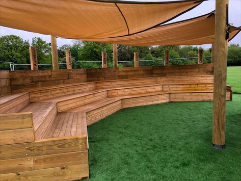 Bespoke outdoor classroom amphitheatre which has a seating area for 60 children with a covered sail to provide for sun and rain shade and with a special enclosed stage and performance area.

This outdoor classroom ampitheatre is the perfect idea for your elementary or preschool to provide a learning area for education outside. Outside Learning Area, Outdoor Classroom Seating, Outdoor Stage Architecture, Mini Amphitheatre, School Courtyard Ideas, Outdoor Classroom Ideas, Outdoor Music Area, Color Wheel Matching, Outside Classroom