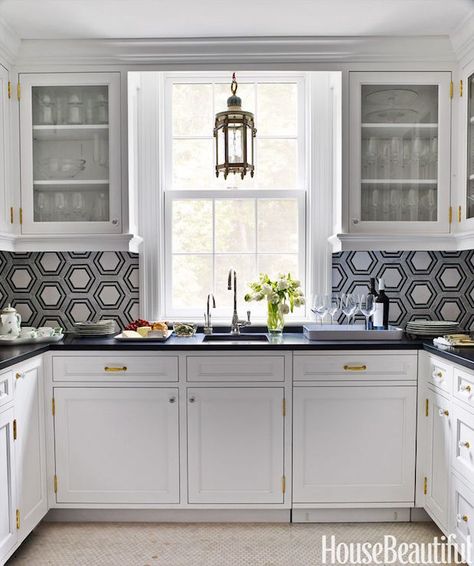 Gorgeous U shaped butler's pantry features glass-front upper cabinets and white lower cabinets unified by brass hardware paired with a honed black countertop and white and gray hex tiled backsplash. Contemporary Kitchen Tiles, Backsplash With White Cabinets, Trendy Kitchen Backsplash, Preppy Kitchen, Pantry Design, Upper Cabinets, Kitchen Tiles Backsplash, Kitchen Tiles, White Cabinets