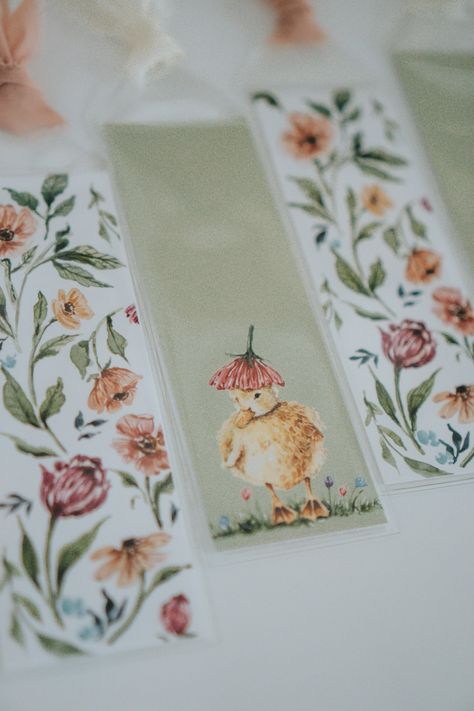 Spring Duckling and Flower Watercolor Paper Bookmarks I LOVE reading. I hope these bookmarks bring you as much joy as they did for me to make! Two styles to choose from each with a different colored chiffon ribbon.  FREE SHIPPING FIRST CLASS (shipping upgrades available at checkout if you want it faster) This bookmark was hand painted by me, scanned in, printed, and packaged in a vinyl sleeve with a chiffon ribbon. DETAILS * 6.25in x 2.25 inches * Blank on the backside  * Packaged in vinyl sleeve with velvet ribbon * Shipped in a sturdy stay flat mailer This item is created with so much love! Image will have slight variations in ink, and may have more details not reflected in the photo(s) due to lighting and your computer monitor screen. --------------------------------------- Check out my Bookmarks Watercolor, Vinyl Sleeve, Spring Watercolor, Craft Booth Displays, Creative Bookmarks, Chiffon Ribbon, Paper Bookmarks, Watercolor Bookmarks, Flower Watercolor