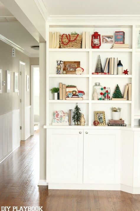 Adding a few red and green accessories to your bookshelves gets your entire home ready for the holiday season. Love this simple, yet traditional look for Christmas. Christmas bookshelf styling. #christmas #christmasdecor #christmascrafts #christmasideas #christmasdecorations #christmastree #holiday #homedecor #homedecorideas Christmas Bookshelf, White Built Ins, Diy Playbook, Holiday 2022, Pop Of Red, Bookshelf Styling, Diy Holiday Decor, Bookshelf Decor, Shelf Styling