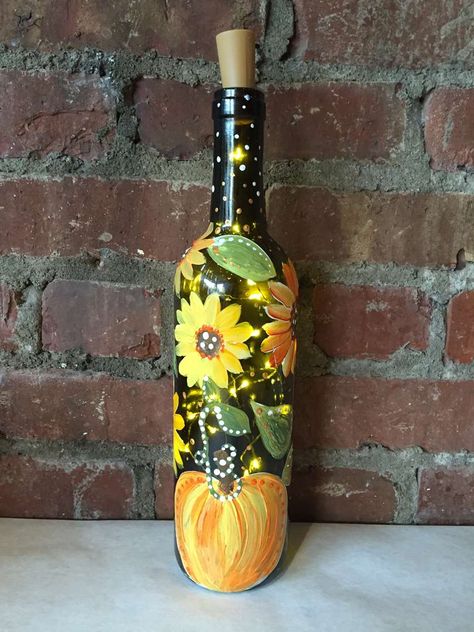 Fall Painted Bottles, Fall Painted Wine Bottles, Fall Wine Bottle Crafts Diy, Porch Crafts, Fall Wine Bottle, Thanksgiving Wine Bottle, Wine Bottle With Lights, Painting Bottles, Fall Wine Bottles