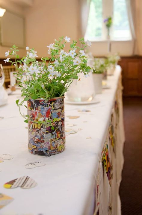 Comic book covered tin with living flowers for wedding centrepiece. Comic book and music score heart confetti Comic Book Centerpieces, Cloud Centerpieces, Spiderman Wedding, Avengers Wedding, Batman Wedding Rings, Comic Wedding, Gold Wedding Band Set, Marvel Wedding, Comic Book Wedding