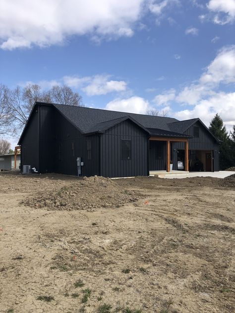 Black Steel House Exterior, Black Steel Roof House, Black Board And Batten House, Metal Batten Siding, Black Metal Board And Batten Siding, Black House With Black Metal Roof, Black House Metal Roof, Metal Siding Cabin, Standing Seam Metal Siding