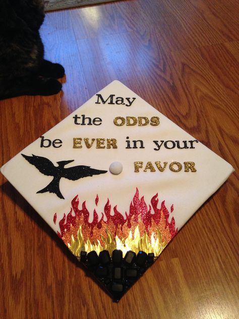 Hunger Games graduation cap. "May the odds be ever in your favor" Fire Graduation Cap, Hunger Games Grad Cap, Nerdy Graduation Cap, Httyd Graduation Cap, Hunger Games Graduation Cap, Avatar The Last Airbender Graduation Cap, Avatar Graduation Cap, Hunger Games Party Decorations, High School Graduation Cap Designs