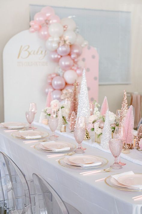 Step into a winter wonderland fit for a little princess! 🎀❄ Our 'Baby, It's Cold Outside' themed baby shower for a baby girl is a dream come true. Imagine pink Christmas trees glistening in faux snow, surrounded by fresh florals that add a touch of elegance. Our event is a vision of loveliness, with larger-than-life pink Christmas trees and enchanting balloon backdrops that set the stage for a magical celebration. Elegant Winter Wonderland Party, Pink Christmas 1st Birthday, Pink Baby Shower Winter, Pink Winter Wonderland 1st Birthday, Baby Its Cold Outside Baby Shower Ideas For Girl, Sweet One Christmas Birthday, Winter Wonderland Pink Baby Shower Ideas, Pink Winter Wonderland Party Decorations, Winter Pink Baby Shower Ideas