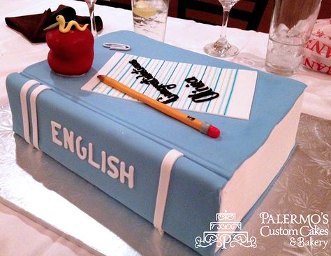 A 3D graduation book cake made in blue fondant. This english book cake has a fondant apple & bookworm sculpted in sugar. The fondant was sculpted over the book cake to appear like closed pages. On top of the book cake is a sculpted pencil in sugar and a sugar note pad with a congratulatory inscription. Palermo’s can custom make a special event cake for your upcoming events, whether they are a similar graduation book cake or another splendid work of cake art! Palermo's custom graduation cakes Study Cake Design, English Teacher Birthday Cake, Teacher Theme Cake Design, Cakes Books Design, Book Graduation Cakes, Teacher Birthday Cake, Teachers Day Cake, Library Cake, Graduation Cake Book Design