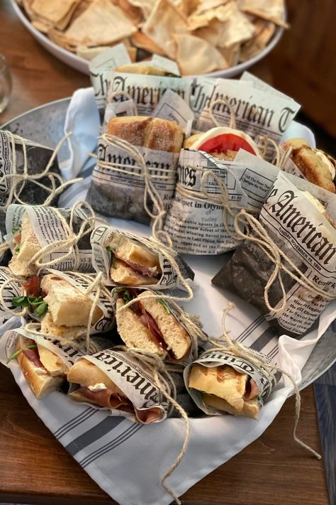 Newspaper wrapped sandwich, italian sandwich, party appetizer, finger foods Newspaper Sandwich Wrap, Sandwich Party Decorations, Finger Foods Packaging, Sandwich Wrapped In Paper, Wrap Packaging Food, Deli Themed Party, Paper Wrapped Sandwiches, Sandwich Shop Aesthetic, Sandwich Packaging Ideas