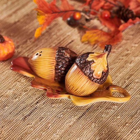 This Harvest Acorn Salt and Pepper Set with Tray is designed to resemble oversized acorns on a leaf shaped tray, bringing a seasonal touch to your table, and is ideal for everyday use throughout the fall season. • Set includes (2) Acorn Shakers, 1 each: 3-1/4 inch long x 1-3/4 inch diameter x 1-3/4 inch high; 2 inch long x 1-3/4 inch diameter x 2-1/2 inch high; and 6-1/2 inch long Tray • Crafted of Earthenware • Handwashing Recommended • Packaged in a brown box