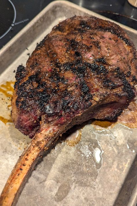 a photo of a grilled tomahawk ribeye steak on a roasting pan Best Ribeye Steak Recipe Grilled, Porterhouse Steak Recipe Grill, Christmas Steak, Grilled Tomahawk Steak, Porterhouse Steak Recipe, Tomahawk Ribeye, Ribeye Steak Recipes, Tomahawk Steak, The Best Steak