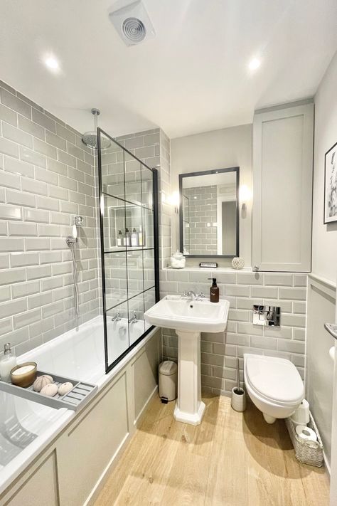 ✨ Classic charm meets modern sophistication in this timeless bathroom design! 🛁 The soft grey metro tiles paired with traditional elements like the pedestal basin create a sleek yet cosy feel. The wood-effect flooring adds warmth, while the black-framed shower screen introduces a bold, industrial touch. Perfect for a relaxing soak or refreshing start to the day. 🕯️🤍 @HouseNumberThree Grey Metro Tiles Bathroom, Metro Tiles Bathroom, Blue Toilet, Cosy Bathroom, Timeless Bathroom Design, Small Full Bathroom, Wood Floor Bathroom, Grey Bathroom Tiles, Vintage Bathroom Decor