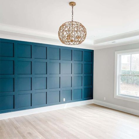 This unfurnished master bedroom with light wood flooring features a white frame window with white trim fitted into a gray wall. Teal is used as an accent color on a stunning board and batten feature wall. A rattan pendant light mounted to the ceiling adds coastal vibes to the room. Teal Board And Batten, Teal Accent Wall Bedroom, Blue Feature Wall Bedroom, Board And Batten Feature Wall, Batten Feature Wall, Teal Blue Bedroom, Light Wood Flooring, Blue Feature Wall, Teal Accent Walls