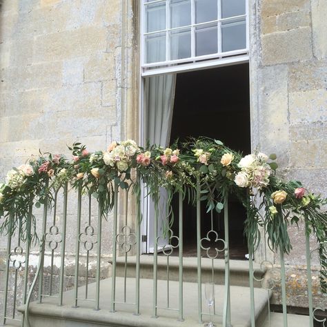 Flower and foliage garland on the railings at Elmore Court by JennyFleur Staircase Garland Wedding, Flowers On Railing, Railing Decorations For Wedding, Event Showroom, Parisian Flowers, Wedding Greenery Garland, Wedding Staircase, Foliage Garland, Elmore Court