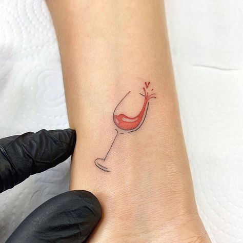 CafeMom.com : Tiny Tribute Tattoo : 20 Wine Tattoos We Happily Raise a Glass To -- A small tribute to wine can still show a big love for the good stuff. This tiny tattoo has just a splash of color (pun totally intended) and is small enough to easily be hidden, depending on the location. The style is also notably simple, but it still is executed perfectly. Wine Glass Tattoo, Wine Tattoo, Glass Tattoo, Tribute Tattoos, Food Tattoos, Hidden Tattoos, Bottle Tattoo, Coffee Tattoos, Inspiration Tattoos