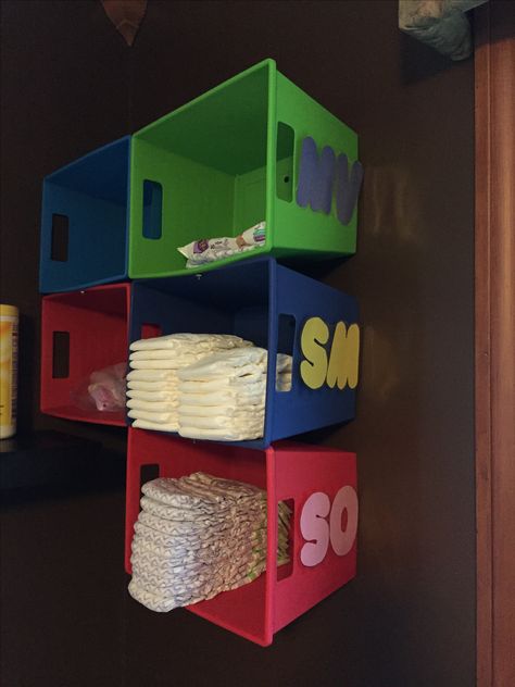 Inexpensive Diaper cubbies. These are made from colorful bins from the dollar store.  Each day care child has their own bin.  Parents can easily view and see when it is time to refill. Daycare Rooms Setup Storage Bins, Day Care Set Up Ideas, Daycare Diaper Organization, Home Daycare Organization, Daycare Storage Ideas, Daycare Toddler Room Ideas, Day Care Decor, Daycare Bathroom Ideas, Baby Classroom Ideas Daycares