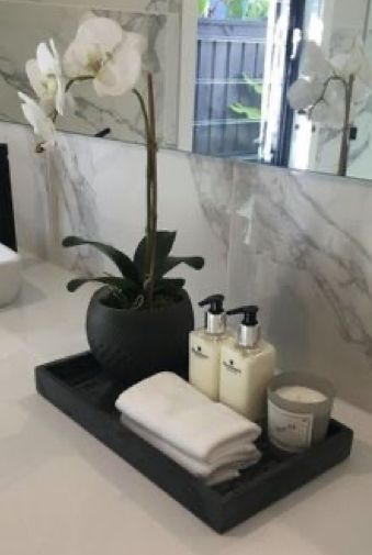 Bathroom Sink Decor Ideas Modern, Over Tub Decor Ideas, Tray For Center Table, Decor For Either Side Of Tv, Black Metal Tray Decor, Modern Chic Bathroom Decor, Cool Tones Bathroom, Simple Elegant Apartment Decor, Bathroom Body Wash Storage