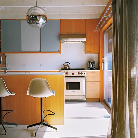 A Mirror Ball pendant by Tom Dixon hovers over the kitchen counter. Photo by: Richard Foulser | Dwell Kitchen Cabinet Dimensions, 60s Kitchen, Cabin Renovation, Entertainment Center Kitchen, Cabinet Dimensions, Mid Century Modern Kitchen, New Kitchen Cabinets, Decoration Kitchen, Mid Century Kitchen