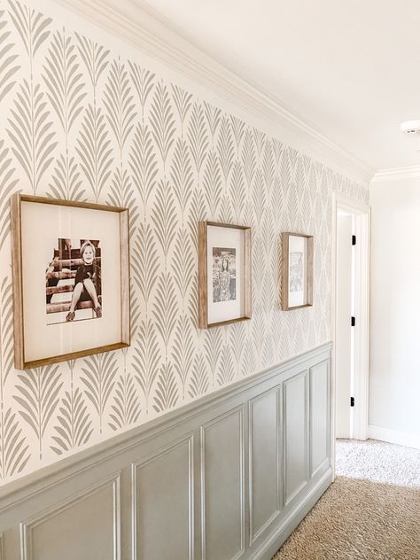 This hallway needed a makeover badly! I chose a stencil from stencil revolution and my husband put up wainscoting. Base color is SW alabaster #hallwayideas #hallwaydecor #wallpaper #frenchcottage #farmhousedecor #gallerywallideas #wainscoting #wainscotingstyles #farmhousedecor #paintcolorideas #frenchfarmhouse Bedroom Wallpaper Half Wall, Board And Batten Wall Wallpaper Above, Wallpaper Down Hallway, Paneled Entryway Foyers, Office Wallpaper Accent Wall Home Office, Painted Wanes Coating Wall Colors, Hallway Paint Colors With Wainscoting, Modern Farmhouse Dining Room Wallpaper, Wall Treatments For Hallways