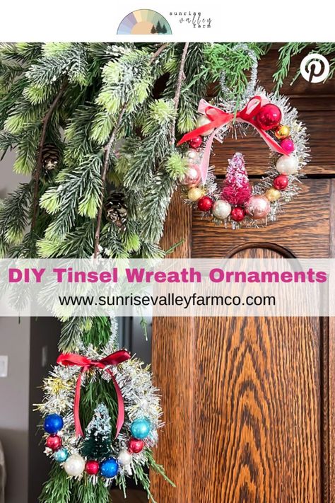 Handmade Tinsel Wreath Ornaments with Vintage Style] Miniature wreath ornaments adorned with shiny red, gold, blue, and silver baubles hang from snowy pine branches, each topped with a red ribbon. A small, festive tree sits inside each wreath. Text on the image says, "DIY Tinsel Wreath Ornaments, www.sunrisevalleyfarmco.com. Tinsel Ornaments Diy, Diy Tinsel Wreath, Tinsel Wreath Diy, Diy Gift Toppers Christmas, Christmas Ornament Wreath Diy, Diy Tinsel, Diy Ornament Wreath, Ornament Wreath Diy, Tinsel Wreath