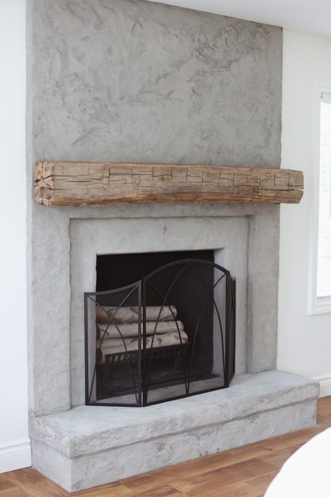 concrete fireplace with reclaimed wood mantel Faux Concrete Wall Fireplace, Concrete Fireplace With Hearth, Stucco Fireplaces Indoor, How To Build An Indoor Wood Burning Fireplace, Real Wood Fireplace Ideas, Wood Frame Fireplace, Cement Fireplace With Wood Mantel, Stucco Fireplace With Wood Mantel, Micro Cement Fireplace