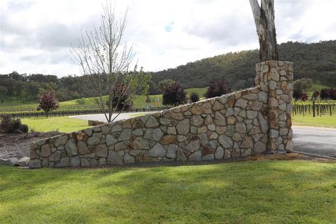 Glenrowan Granite stone wall entrance gates www.mawsons.com.au Stone Wall Gate Entrance, Stone Entrance Driveway, Stone Gate Entrance, Stone Fence Ideas, Granite Stone Wall, Farm Gates Entrance, Stone Entrance, Ranch Entrance Ideas, Landscaping Entrance