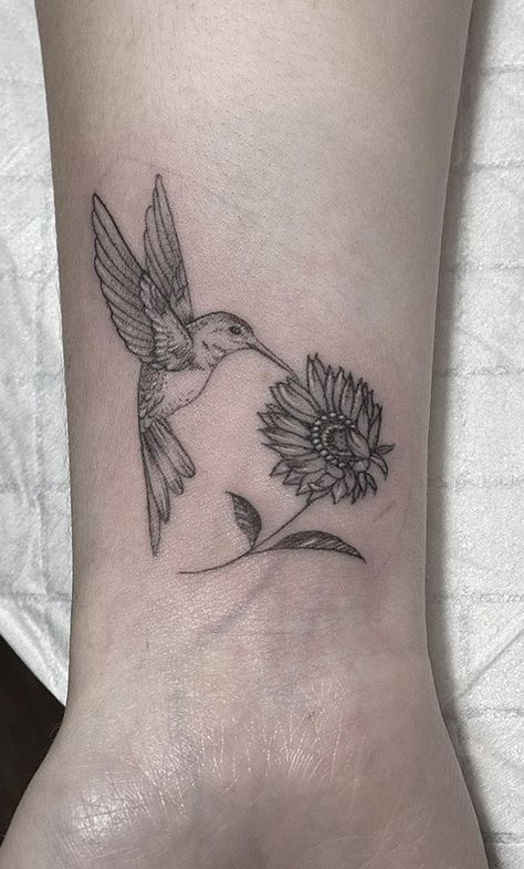 Sunflower Tattoos: Meanings, Tattoo Styles & Ideas Daisy Hummingbird Tattoo, Humming Bird With Sunflower Tattoo, Hummingbird Tattoo For Loved One, Hummingbird Upper Arm Tattoo, Pretty Hummingbird Tattoo, Humming Bird Memorial Tattoos, Hummingbird Daisy Tattoo, Hummbird Tattoos, Hummingbird Tattoo On Wrist