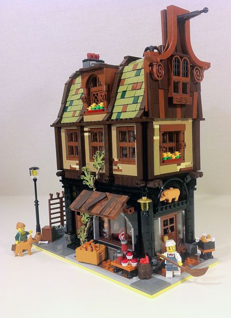 https://flic.kr/p/qUbyuc | Butcher Shop | As a brother to my Dairy Shop, I've just finished the second addition to my WIP; Old Town Square: a Butcher Shop!  This shop has been in the family for centuries! It's well known among the locals for its fresh products and great service! Mr Butcher likes to keep his little stoop nice and clean for his customers.  Primarily using the colors black, dark brown, dark tan and olive green, this building is noticeably darker than my Dairy Shop. It has plent... Creator Inspiration, Lego Structures, Lego Elves, Lego Houses, Lego Village, Lego Techniques, Lego Winter, Lego Medieval, Lego Buildings