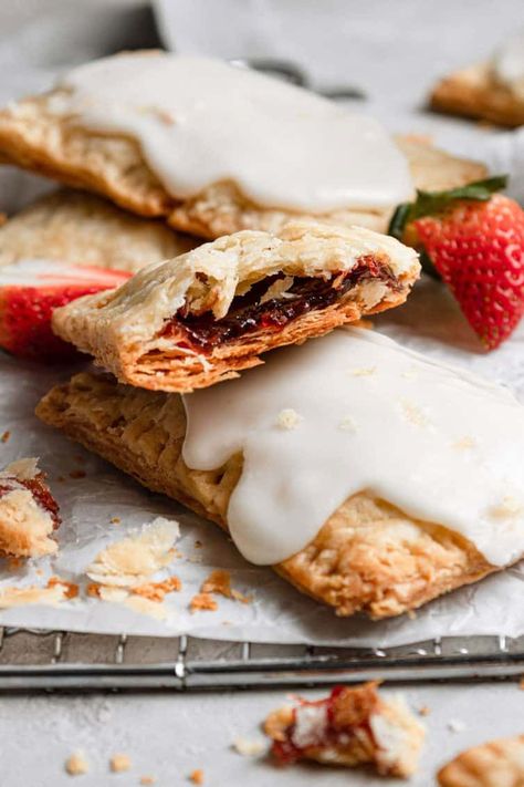 These easy, yet totally impressive homemade strawberry pop tarts are the perfect addition to your morning breakfast. Flaky pastry surrounds strawberry filling for a tender breakfast pastry that will disappear in a matter of minutes. Get ready to go completely berserk over this amazing homemade version of one of my childhood favorite treats! Pop Tarts Recipe, Brown Sugar Pop Tarts, Strawberry Pop Tarts, Filling Breakfast Recipes, Homemade Pop Tarts, Strawberry Pop, Brown Eyed Baker, Strawberry Pop Tart, Tarts Recipe