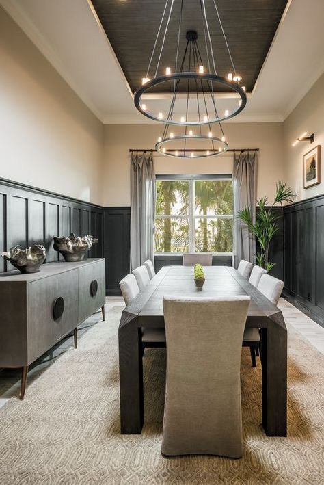 Modern and elegant dining room design highlighted by a tray ceiling and vintage industrial lighting. Black Tray Ceiling, Tray Ceiling Dining Room, Black Wainscoting, Dark Dining Room, Dark Ceiling, Dining Room Wainscoting, Dining Room Design Ideas, Room Accent Wall, Dining Room Design Modern