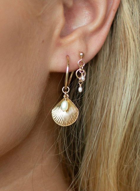 ALANA MARIA JEWELLERY - This enchanting piece will become a favourite in your collection. Captivating upon first glance these earrings feature a charming shell pendant accompanied by a Freshwater Pearl details and delicately hung from a 14k gold-filled Hoop. Adorn yourself with the beautiful Ula Shell Hoop earrings, pair alone or in a stack to achieve a beautifully curated ear. - Sold as a pair- Hoop earring- Shell pendant feature-Freshwater Pearl detail- 14k gold-filled Hoop measurement: 15mm Please note, due to hygienic purposes we do not refund or exchange any Alana Maria Jewellery earrings Alana Maria Earrings, Infinite Jewelry, Alana Maria, Beach Cowgirl, Gold And Pearl Earrings, Shell Accessories, Shell Hoop Earrings, Curated Ear, Surf Jewelry