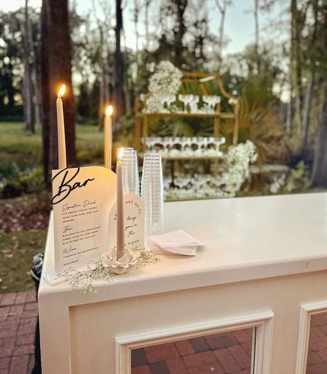 Alexis Doktor on Instagram: "Your guests will likely be spending a lot of time at the bar. Make it something they want to look at! 🍾 Think custom signage (bar top, neon, or both), candles and decor to tie in to the rest of the reception, a decorative shelf for beautiful glassware, and of course a show stopping bar itself! Swipe for more detail pics ✨ Venue - @adamspondsc Bar & rentals - @partyreflections . . . . #weddingday #weddingdetails #weddingdecor #weddingbar #barservice #raisingtheba Diy Wedding Bar, Wedding Bar Decor, Beautiful Glassware, Decorative Shelf, Candle Bar, Wedding 2025, Custom Signage, Bar Top, Wedding Diy