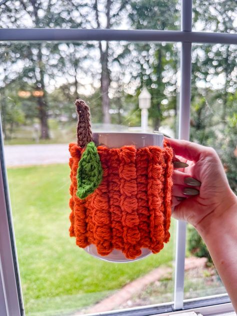 A crochet pumpkin mug sweater not has all the fall vibes but always protects your hands from a hot mug!  Made in a dog friendly and smoke free home.  Care Instructions:  Machine wash on gentle with cool water.  Can by machine dried on low heat but for best results: lay flat to dry.  Made of 100% acrylic yarn. Crochet Mug Sweater, Crochet Holiday Sweater, Mug Sweater, Crochet Projects To Sell, Yarn Projects Crochet, Crochet Pour Halloween, Autumn Crochet, Crochet Mug Cozy, Pumpkin Drinks