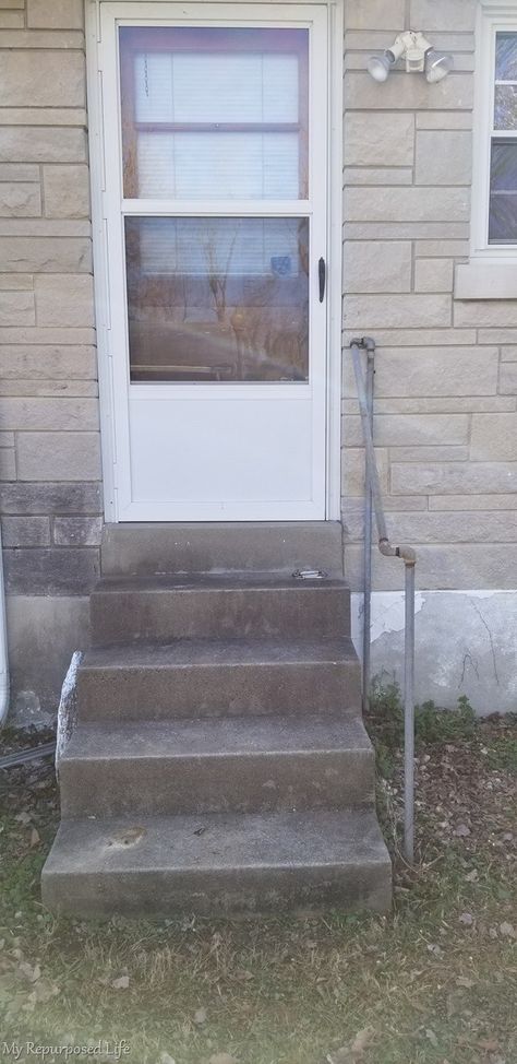 These ugly concrete steps get disguised with a small deck #myrepurposedlife #backdoor #backyard #outdooroverhaul #hangoutchallenge #spon Deck Over Concrete Steps, Front Door Floating Deck, Front Entrance Steps, Cover Concrete Steps, Wood Over Concrete Steps, Covering Concrete Steps With Wood, Small Front Steps Ideas, Cover Concrete Steps With Wood, Covering Concrete Steps With Wood Front Porch