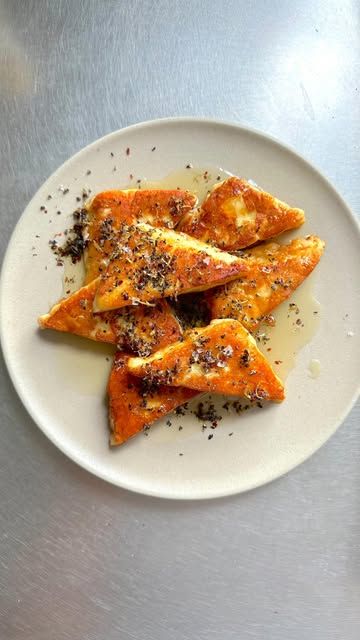 ANDY BARAGHANI on Instagram: "Halloumi with Lemony Honey and Sesame Salt

Fried cheese is one of life’s greatest pleasures, and having experienced many of them, I feel confident saying so. Halloumi, usually a mixture of sheep’s and goat’s milk, is one of the rare cheeses that can be seared. It gets a deep golden, crackly crust.
It oozes, spreads, and loses form. Delicious. It’s also incredibly salty. To tame the salt, I add red pepper flakes and honey. Eat it while it’s hot, as halloumi
can get squeaky and rubbery as it sits (I’ll still eat it)." Andy Baraghani, Fried Cheese, Cheese Fries, Red Pepper Flakes, Red Pepper, Feel Confident, Spreads, Party Food, Sheep