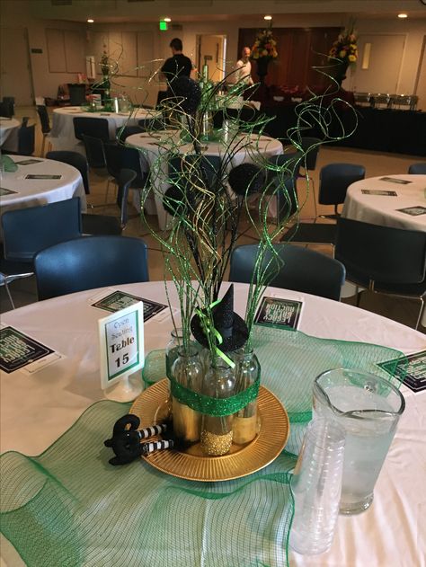 Emerald City/Wizard of Oz themed centerpiece Emerald City Centerpiece Ideas, Wizard Of Oz Gala Ideas, Emerald Green Gala Decor, Wizard Of Oz Quinceanera, Wizard Of Oz Sweet 16 Emerald City, Wizard Of Oz Dinner Party, Wizard Of Oz Sweet 16, Wizard Of Oz Prom Theme, Wizard Of Oz Centerpiece Ideas