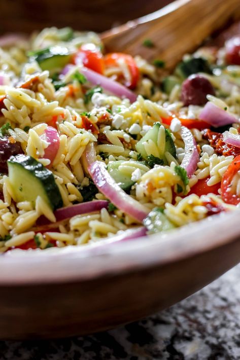 Orzo Salad with Sundried Tomatoes and Feta is a delightfully quick, light and easy lunch or dinner recipe to make! Perfectly cooked orzo pasta is tossed in a homemade zesty vinaigrette with cucumbers, sundried tomatoes, red onions and feta! Serve this Mediterranean inspired orzo salad in the warmer summer months, with grilled meats or seafood or all year round as the perfect meal or side dish! Salad With Sundried Tomatoes, Orzo Pasta Salad Recipe, Mediterranean Orzo, Bruschetta Pasta, Salad Appetizer Cups, Greek Orzo Salad, Orzo Salad Recipes, Quick Lunch Recipes, Orzo Pasta Salad