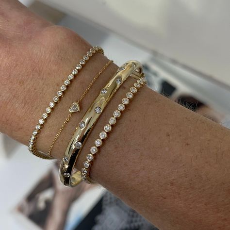 This sleek bangle captivates with scattering flush set diamonds set in 14k gold. Carefully crafted with comfort in mind, this bangle is easy to wear every day and a perfect addition to your stack if you're wanting to add more gold with a touch of sparkle! Available in 14k Yellow Gold, White Gold or Rose Gold Total Carat Weight: 1.75 cts Color: G/H Clarity: VS2 Closure: Hinge Made to order. Lead time is 4 weeks. Benefits of Solid 14k Gold Jewelry Most loved for its durability and longevity Can be Yellow Gold Bracelets, Gold Bracket Stack, Bangles Diamond, Gold And Diamond Bracelet, Flush Set Diamond, Accesories Jewelry, Stacked Bangles, Classy Jewelry, Stacked Jewelry