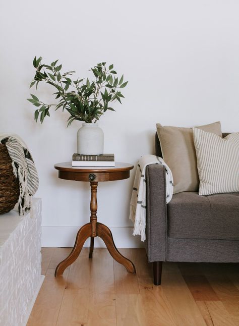 The little round end table trend - My vintage pedestal end table and 15 other little round end tables. Modern Traditional round pedestal tables, hourglass side tables, and 3 legged end tables. | Nadine Stay #endtable #sidetable #roundtable #vintagesidetable #vintagefurniture #moderntraditionaldecor #livingroomdecor #livingroominspo #pedestaltable #hourglasstable #flutedtable Side Tables Traditional, Traditional Side Tables In Living Room, Side Table Decor Living Room Vintage, Vintage Modern Side Table, Antique Wood Side Table, Styling Round Side Table, Small Living Room Side Table, Round Side Table Styling Living Room, Round Dining Centerpiece Ideas