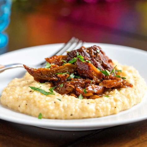 Leftover pork ribs get shredded and simmered in your favorite BBQ sauce and top creamy, cheesy grits for a Southern inspired dinner that's sure to satisfy. Leftover Pork Ribs, Leftover Pork Recipes, Leftover Prime Rib Recipes, Spaghetti With Ground Beef, Bbq Pork Recipes, Comfy Food, Pork Ragu, Bbq Pork Ribs, Cheesy Grits