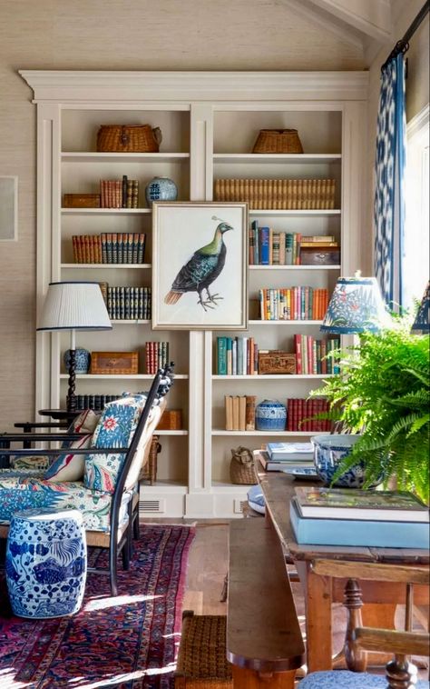 eclectic living room decor ideas: a living room furnished with a vintage oriental rug, a large fern houseplant, antique wood furniture, and a styled bookshelf with framed peacock art Grandmillenial Style, Grandmillennial Style, Mark D Sikes, Home Libraries, Shelf Styling, Living Room Style, Home Library, Southern Living, Living Room Inspiration