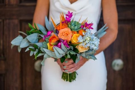 Bride holding a bright color bridal bouquet with birds of paradise and eucalyptus Color Bridal Bouquet, Bird Of Paradise Wedding, Cabo Destination Wedding, Beach Bouquet, Dream Wedding Bouquet, Colorful Bridal Bouquet, Flower Cake Decorations, Prom Bouquet, Flowers Centerpieces