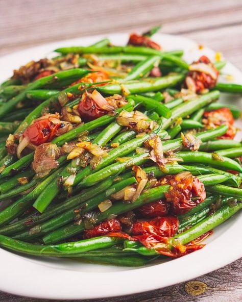 If you need to level up your green beans at Thanksgiving, this is the perfect way to do it. These green beans with tomato confit and shallots are so buttery and garlicky. It doesn Leftover Green Beans, Delicious Green Beans, Green Bean Dishes, Tomato Confit, Shallot Recipes, Comforting Food, Beans With Bacon, Blue Jean Chef, Cooking Vegetables