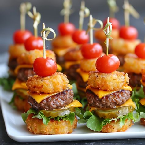 🍔🧀 Bite-sized Mini Tater Tot Cheeseburgers that are sure to be a hit! #PartyFood #Cheeseburger Mini Tater Tot Cheeseburgers Ingredients: Ground beef (1 lb) Salt and pepper (to taste) Cheddar cheese (4 slices, quartered) Tater tots (24, cooked) Lettuce (1/2 cup, shredded) Pickles (12 slices) Cherry tomatoes (6, halved) Toothpicks Instructions: Form ground beef into small patties, season with salt and pepper. Cook patties in a skillet until browned. Top each patty with a cheese quarter. Ass... Burger Bites Appetizers, Individually Wrapped Party Food, Cheeseburger Birthday Party, Meat Cupcakes, Cheeseburger Cups, Gender Reveal Food, Friendship Crafts, One Bite Appetizers, Mini Cheeseburger