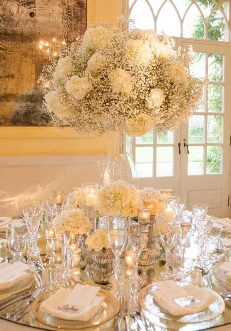 Mirrored Table Tops, Flower Decorations Wedding Table, Moody Lighting Wedding, Mirrored Table Wedding, Top Table Wedding Decor, Mirror Table Top Wedding, Silver And Gold Wedding Decorations, White Silver And Gold Wedding, White And Gold Flower Arrangements